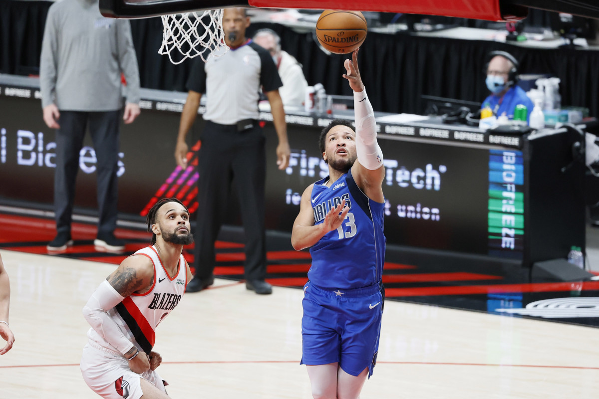 Mar 19, 2021; Portland, Oregon, USA; Dallas Mavericks point guard Jalen Brunson (13) shoots the ball past Portland Trail Blazers shooting guard Gary Trent Jr. (2) during the first half at Moda Center.